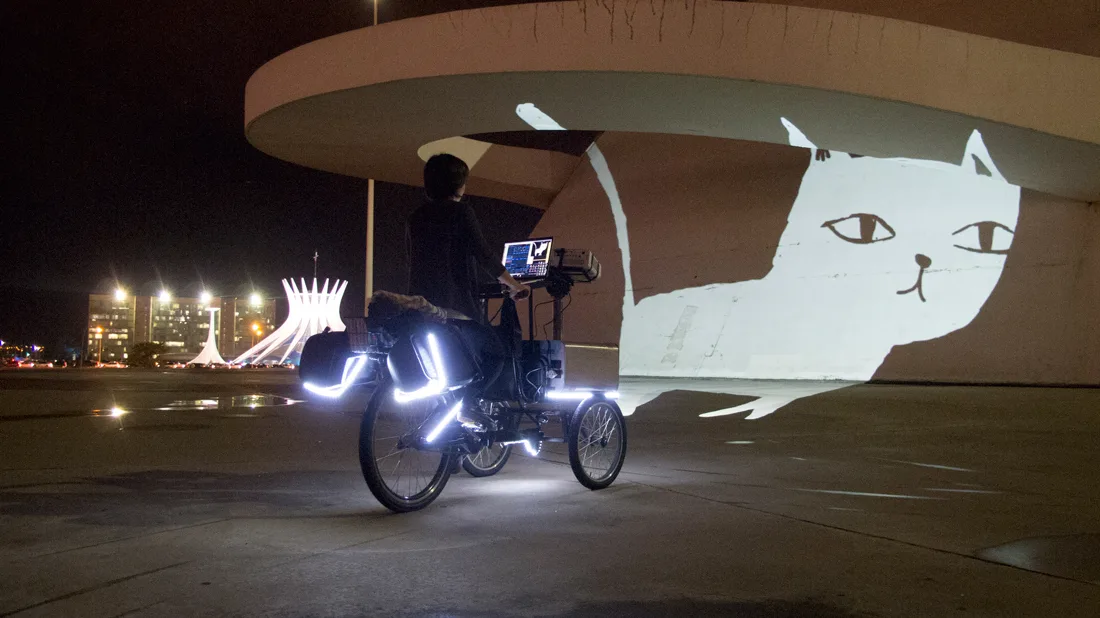 VJ Suave Suaveciclo conducting mobile projection mapping on the walls of the National Museum in Brasilia, Brazil.