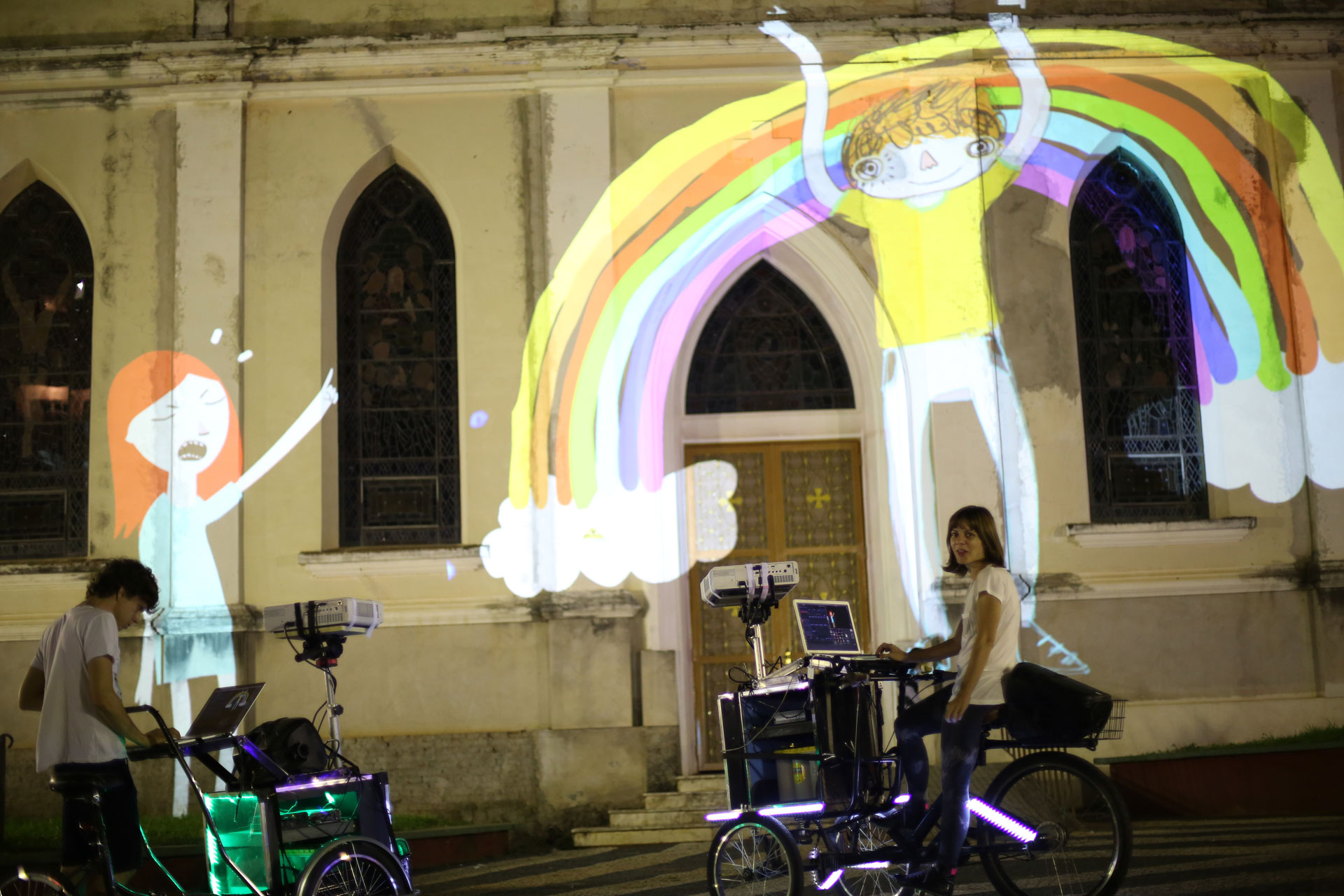 VJ Suave duo and their Suaveciclos conducting mobile projections mapping on a city wall