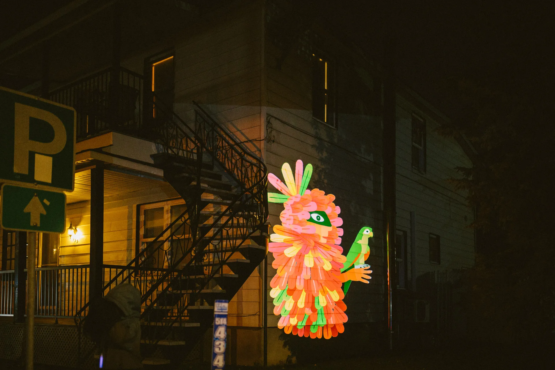VJ Suave Suaveciclo conducting mobile projection mapping on a city wall